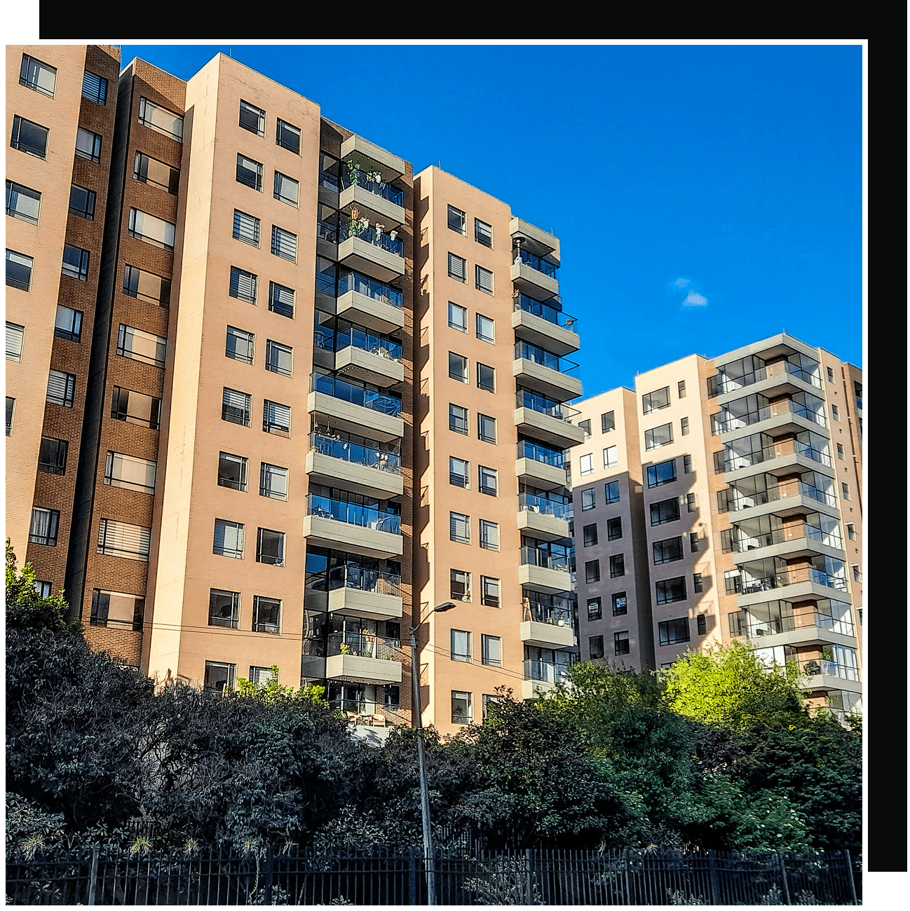 Modern apartment buildings with balconies and trees