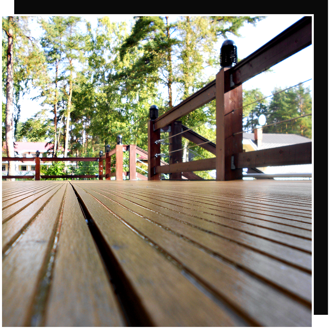 Wooden deck with railing and trees