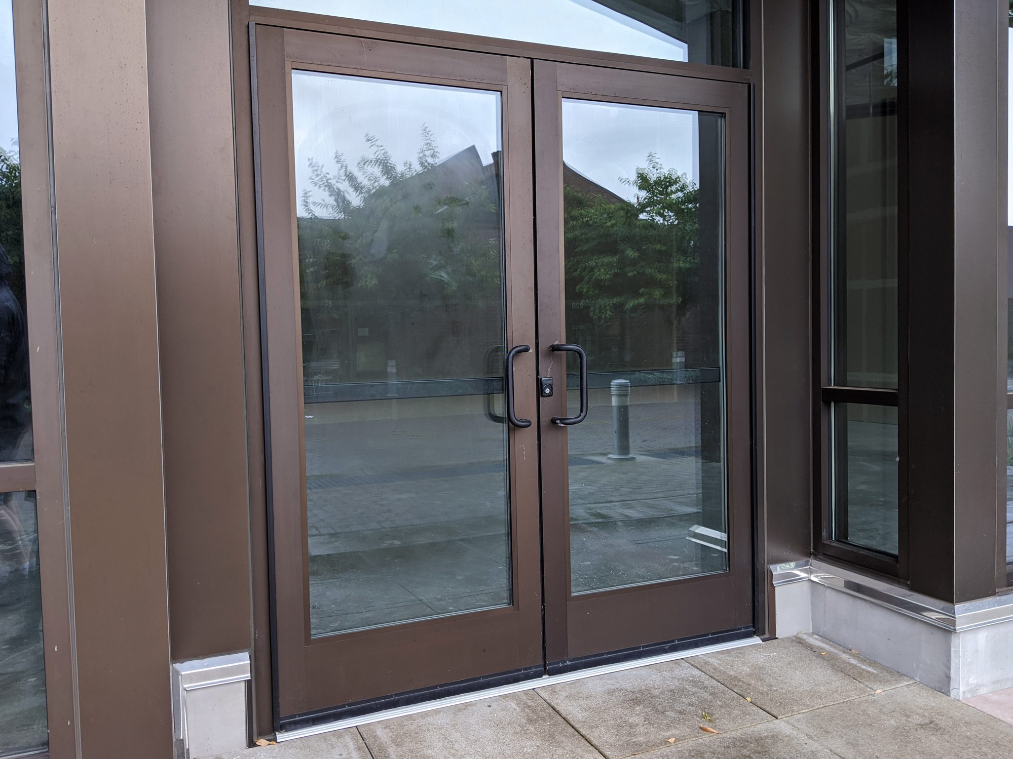 Brown metal-framed double glass storefront doors