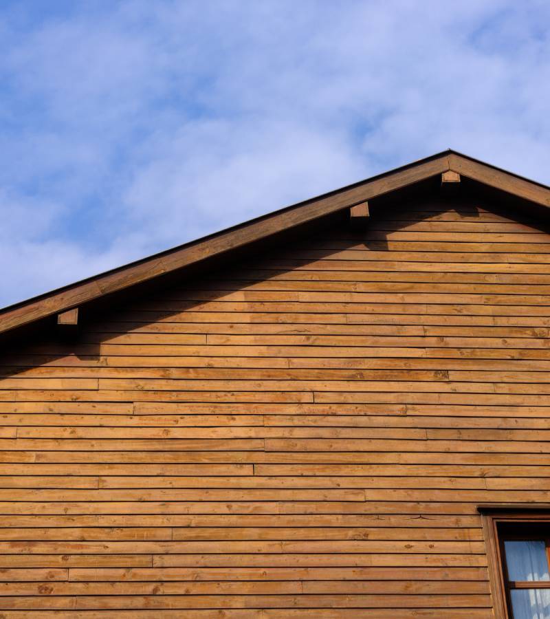 Wooden clapboard gable under blue sky