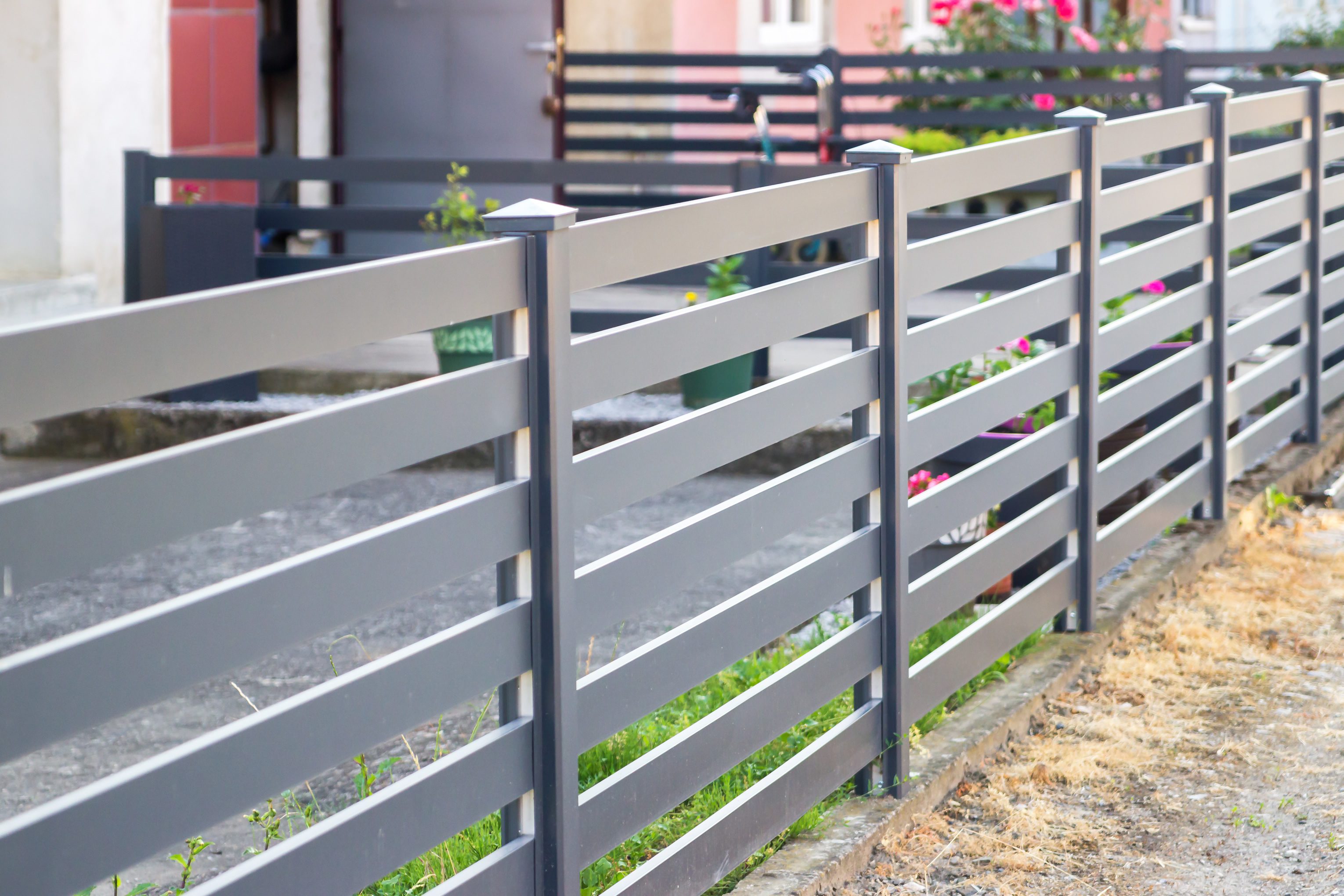 Modern gray horizontal metal slat fence
