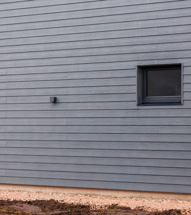 Gray horizontal siding exterior wall with window