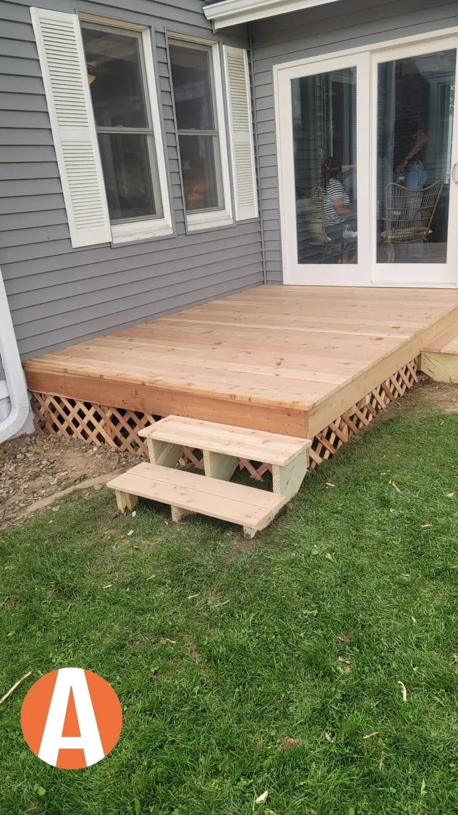 Wooden deck with steps beside house