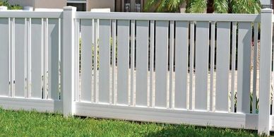 white vinyl fence with green lawn