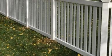 White picket fence along grassy yard
