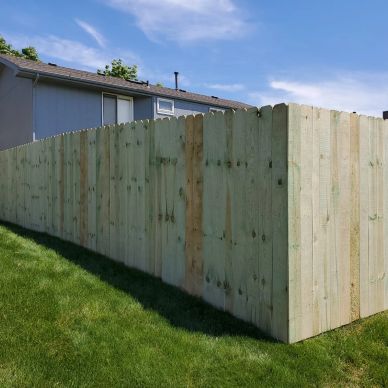 New wooden privacy fence along suburban backyard