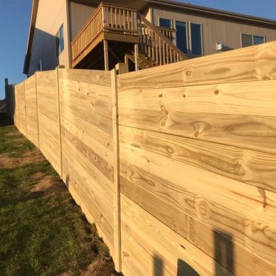 Freshly installed wooden privacy fence by house