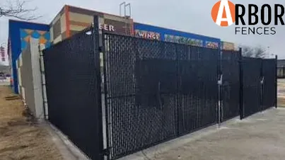 Black chain-link security fence around storefront