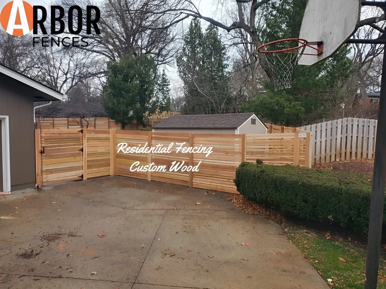Driveway with custom horizontal wood fence