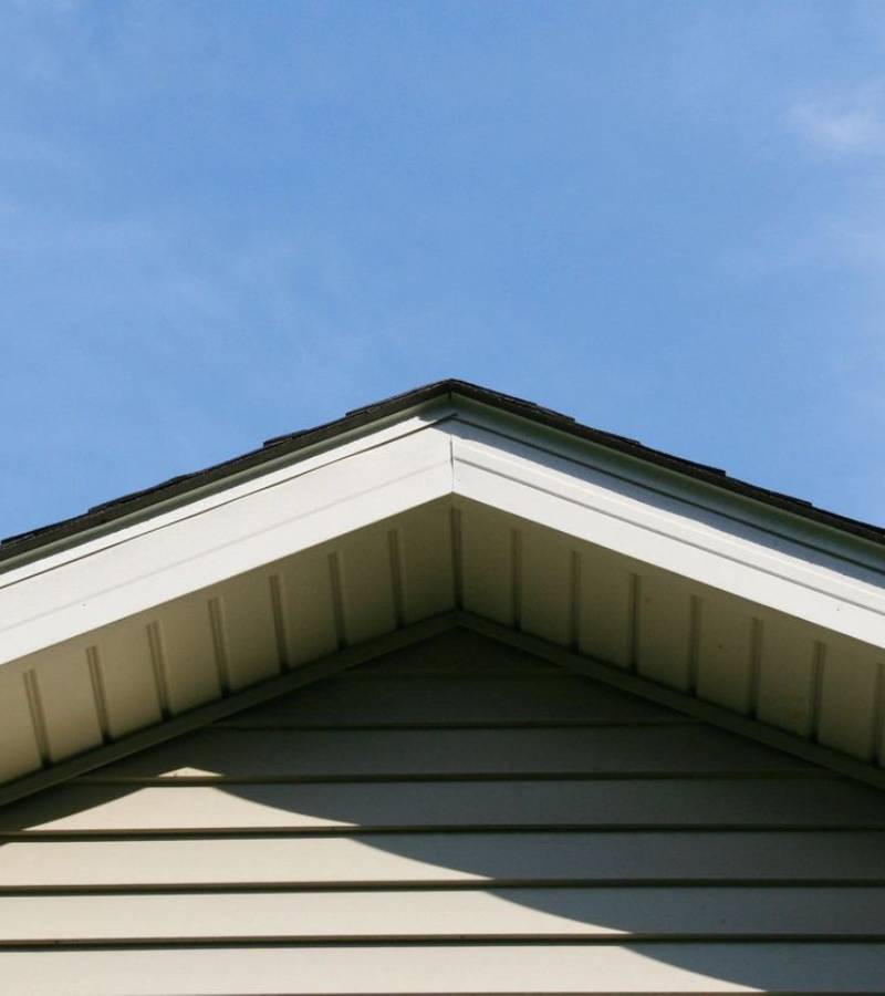 House gable roof peak against blue sky