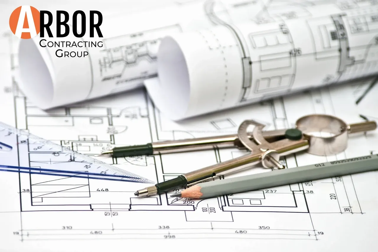 Architectural blueprints with compass and pencils