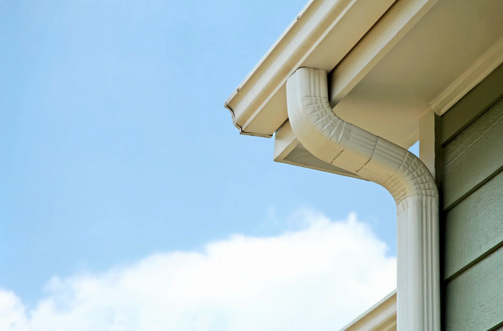 White downspout on house exterior