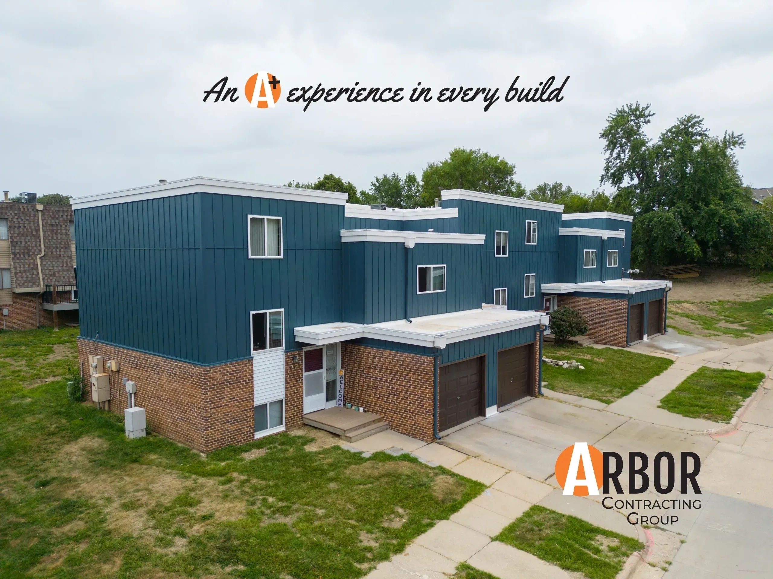 Blue multiunit homes featuring Arbor Contracting logo
