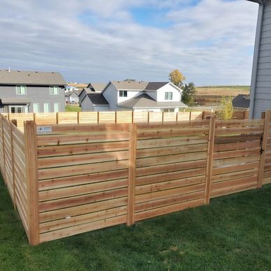 Cedar horizontal privacy fence enclosing suburban backyard