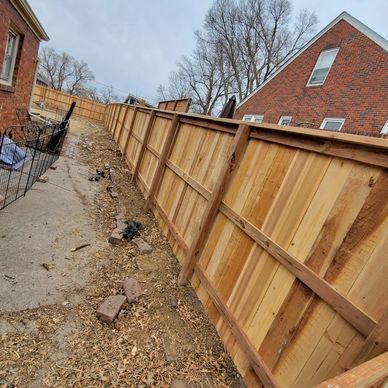 New wooden privacy fence along narrow yard