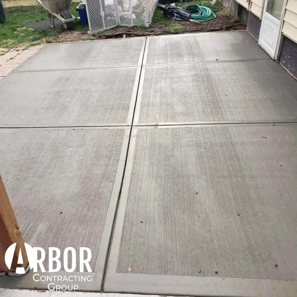 Finished concrete patio slabs near garage