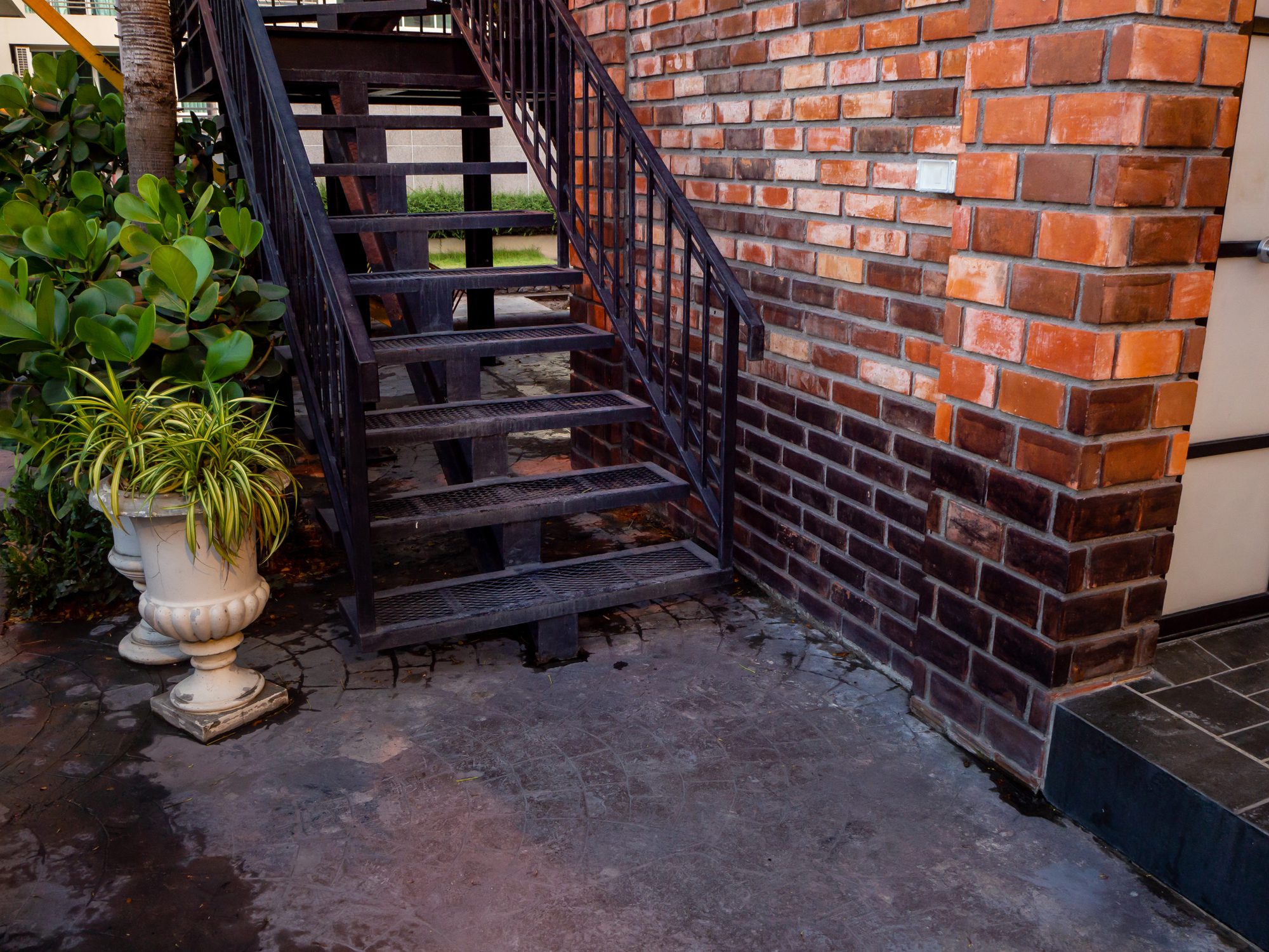 House frontyard cultured veneer stone work siding and rod iron stairs