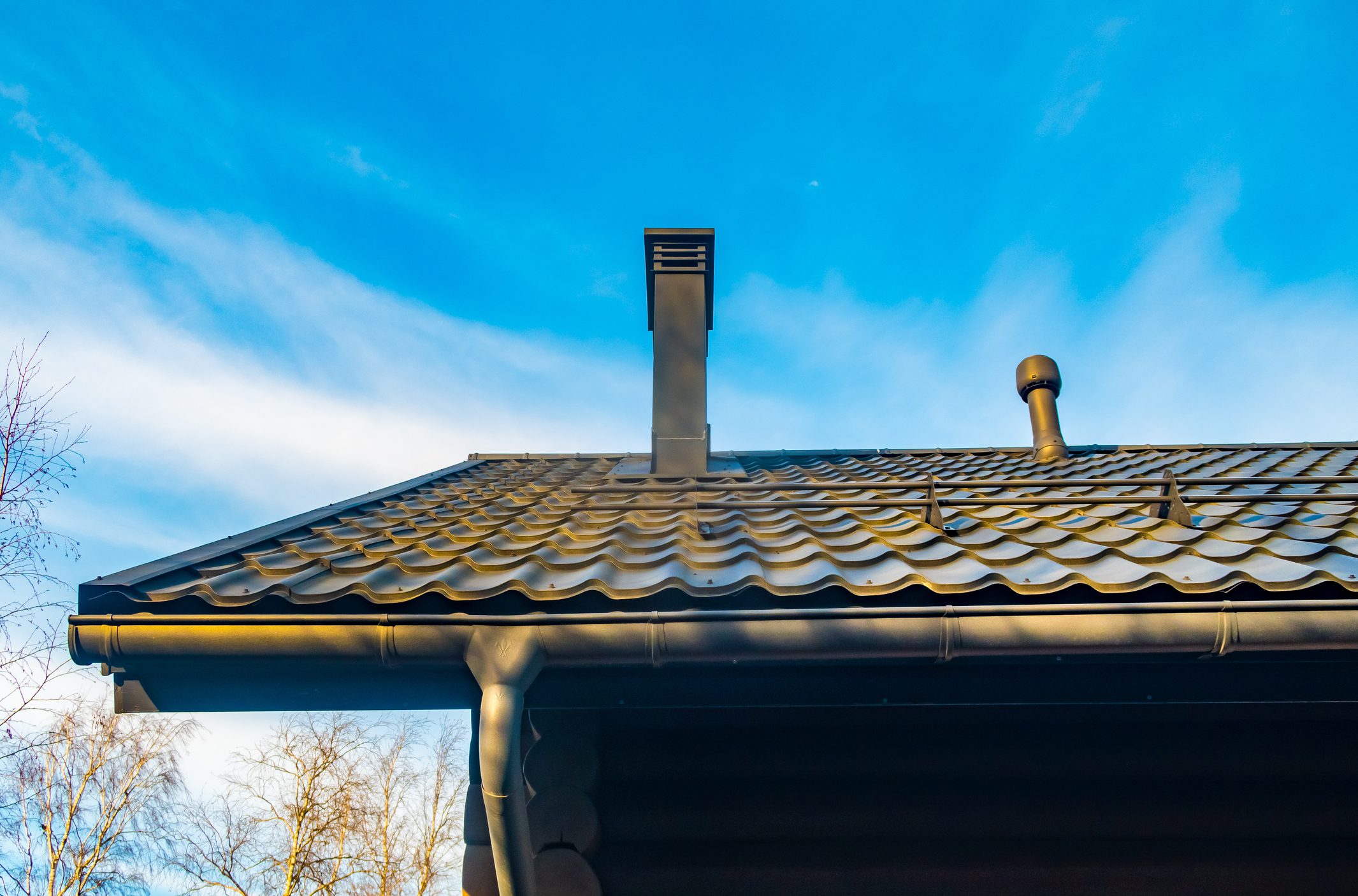 The roof of the house against the blue sky