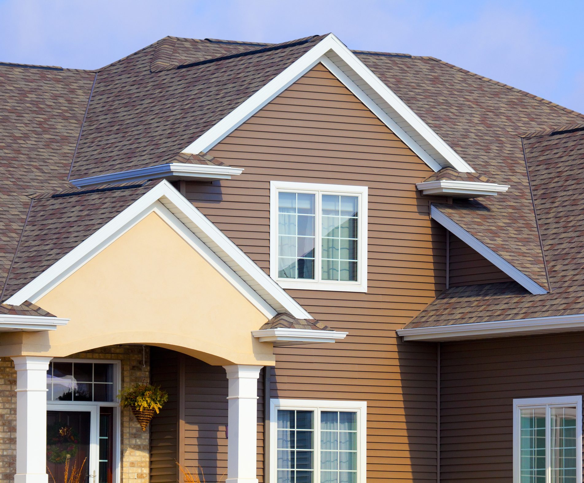 New Home With Brick, Stucco, and Brown Vinyl Siding