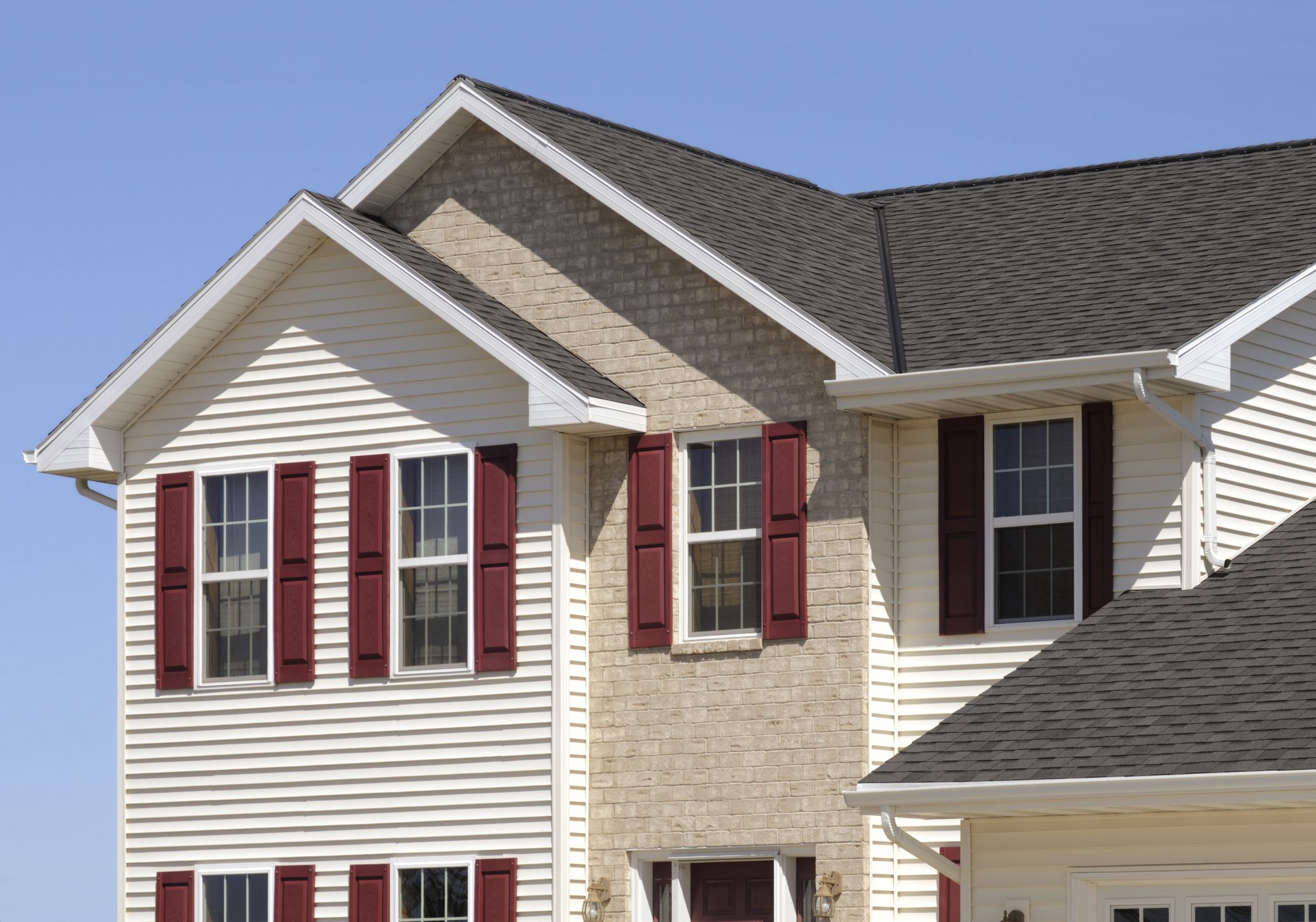 If you require a shot for new home construction or any of the array of building products shown, this would be a great image for you. It shows, architectural asphalt shingle roof, vinyl siding, windows, seamless aluminum gutters, brick, vinyl shutters.