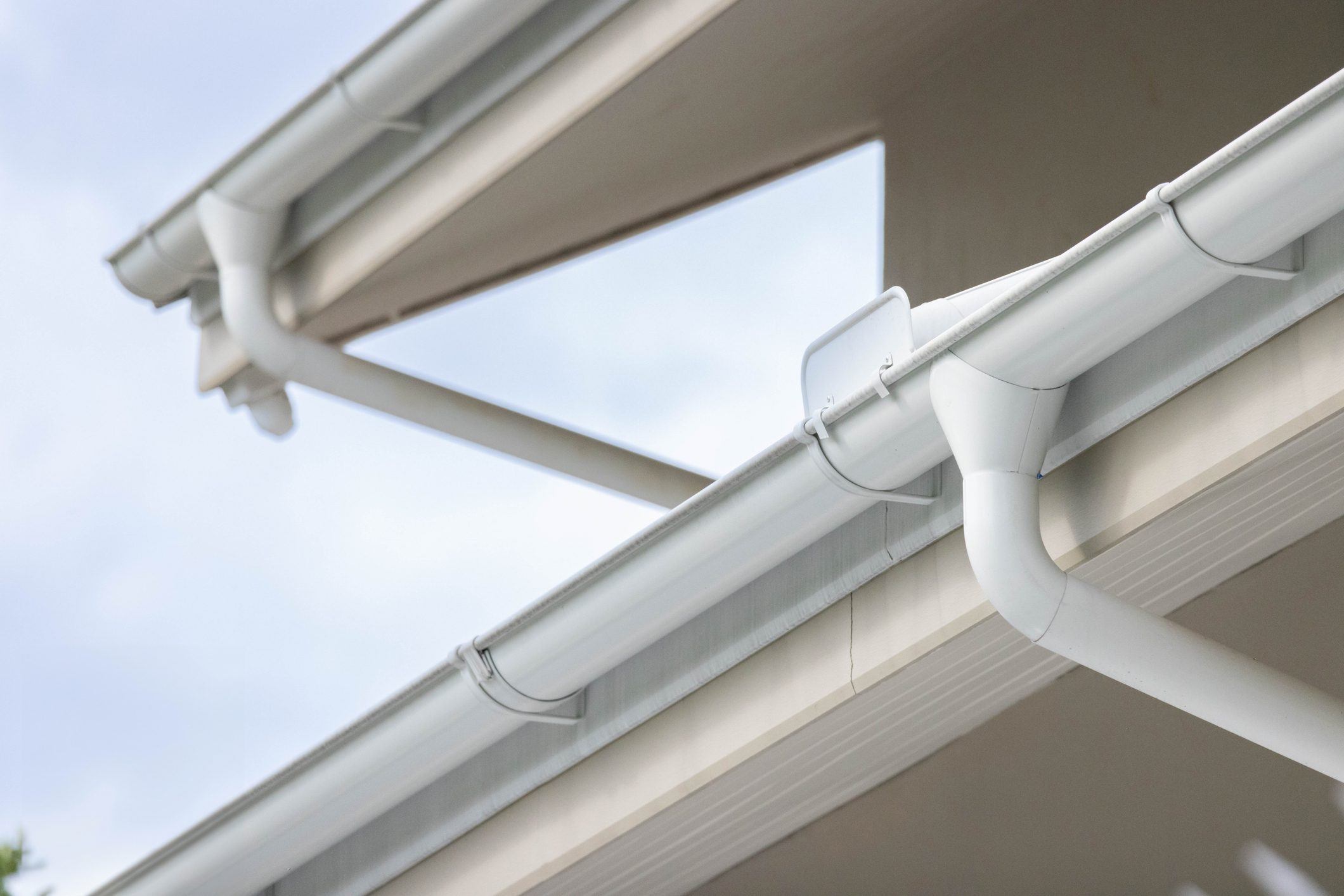 white plastic rain gutter and dark sky. concept : preparing maintenance rain gutter before rainy season.