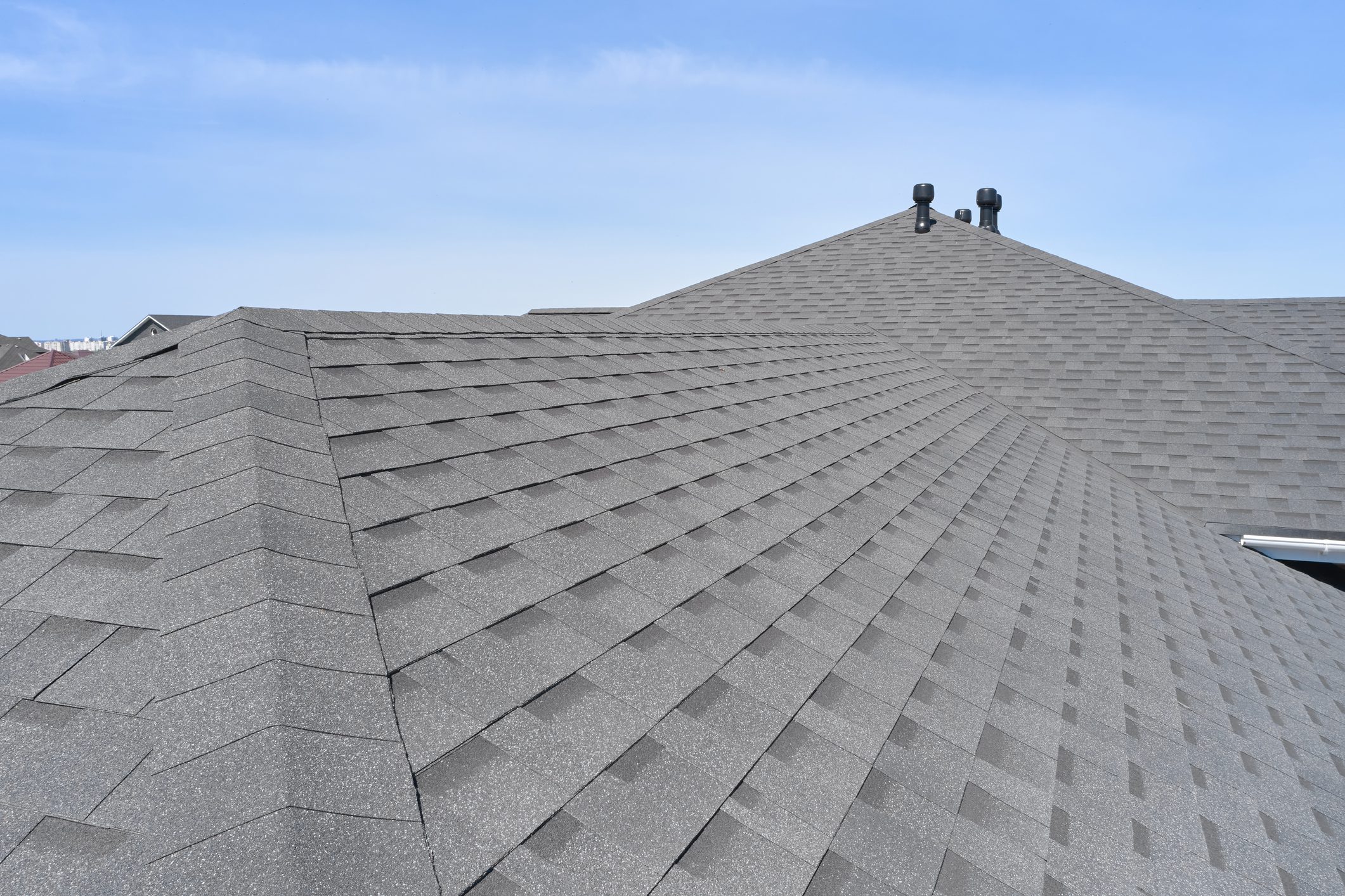 Luxury house roof with asphalt shingles.