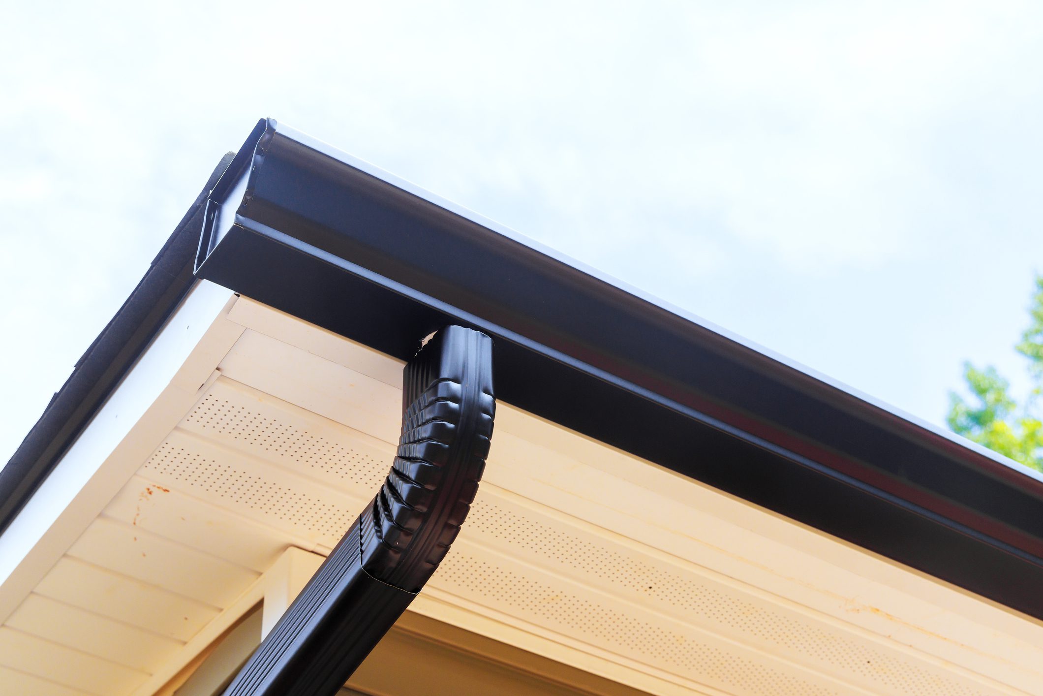 Installing rain gutters on roof installing downpipe, downspout bend