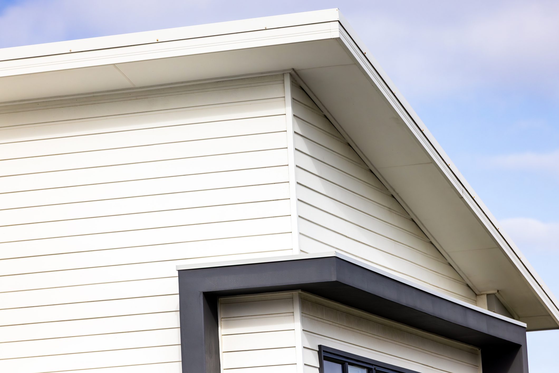 Closeup top part of modern house, background with copy space, full frame horizontal composition
