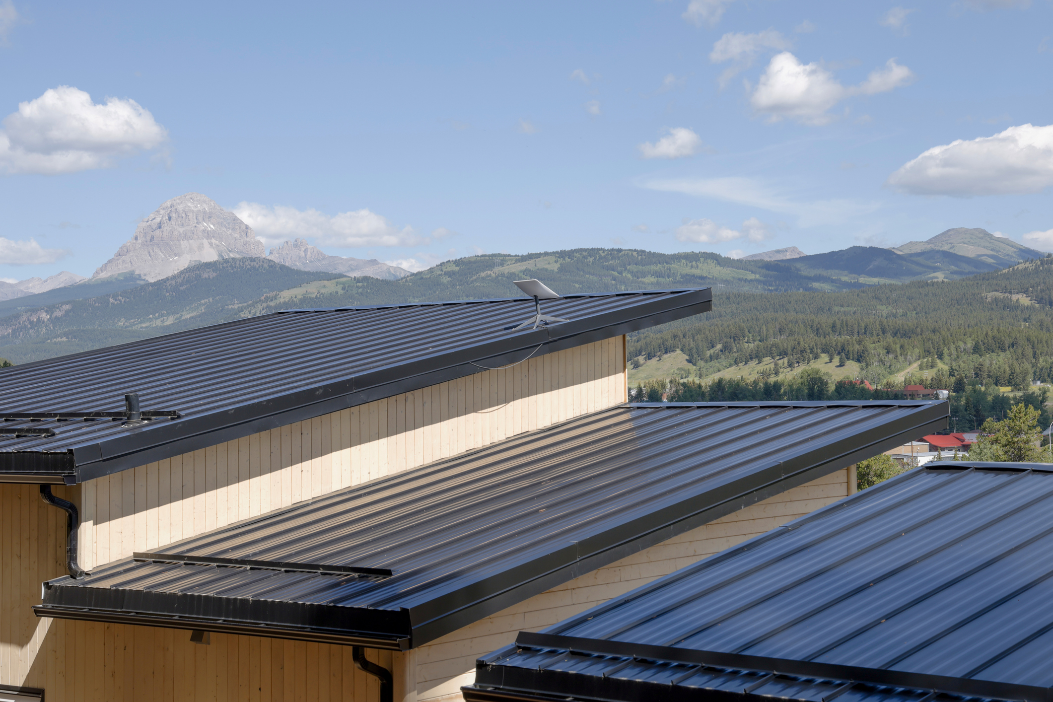 Metal, shed roof and distant mountains at sunrise on a sunny day, Canadian Rockies, Alberta