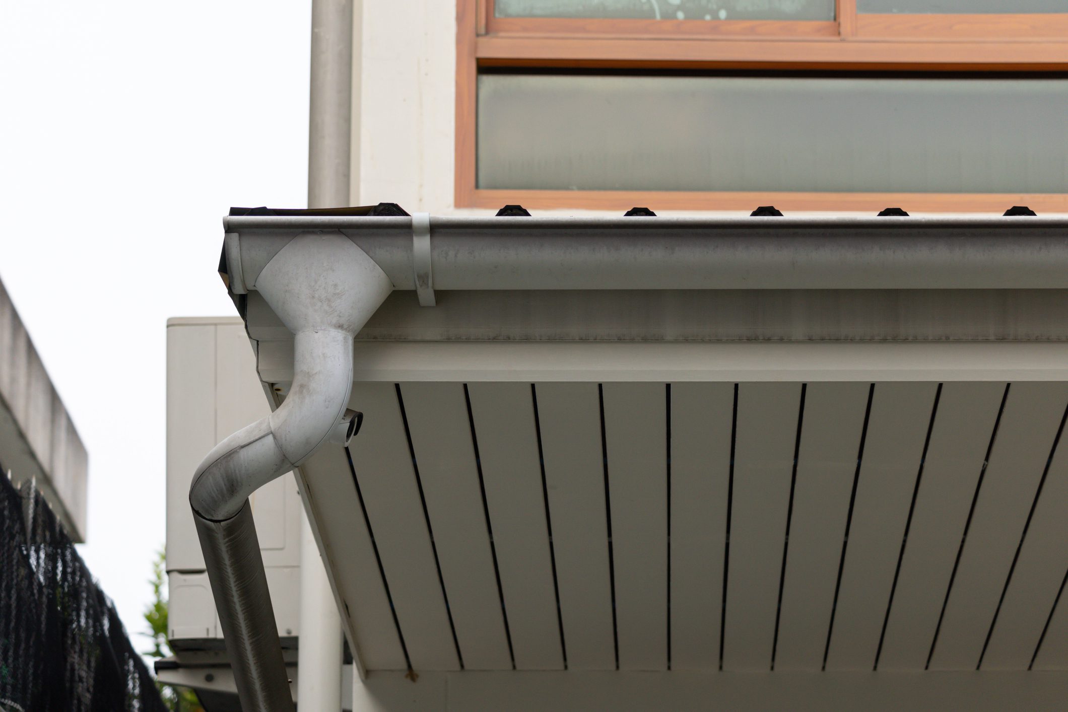 white plastic rain gutter with house background. concept : preparing maintenance rain gutter before rainy season