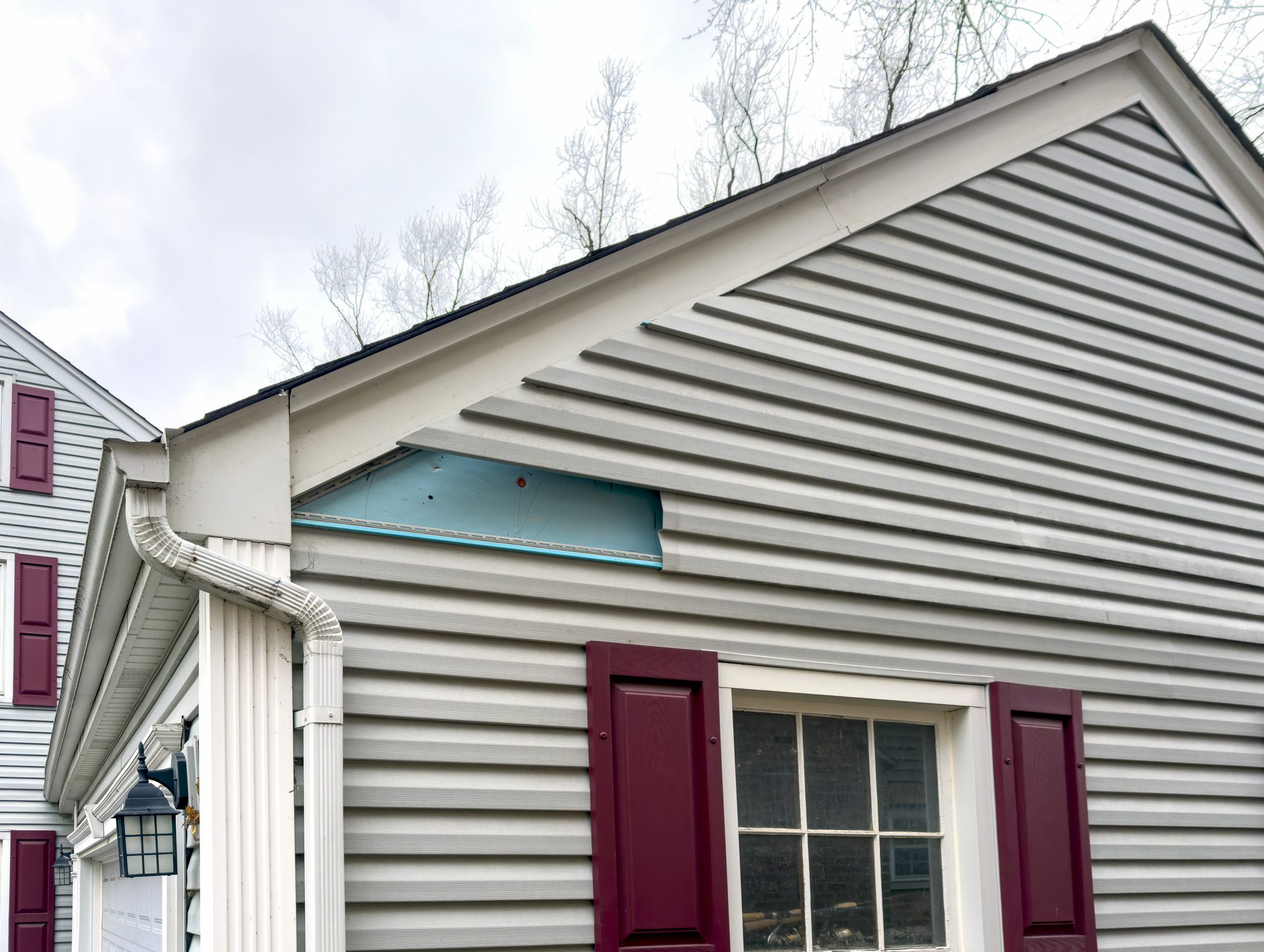 Vinyl siding on garage is missing a section after a huge windstorm
