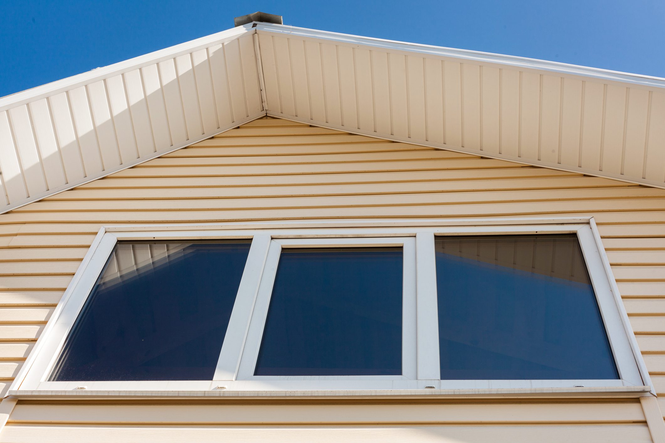 Low angle closeup view of roof upper floors of house