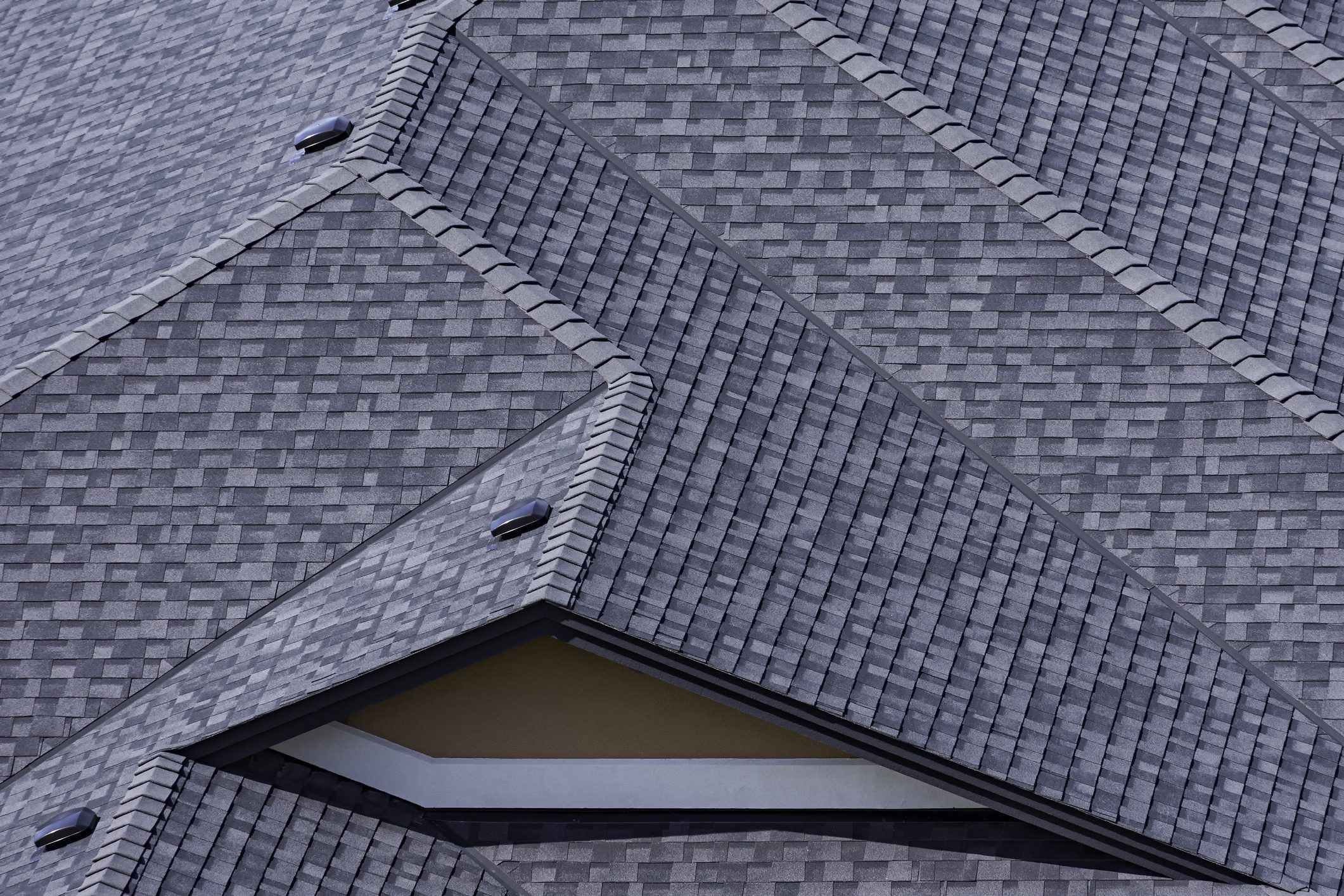 Rooftop in a newly constructed subdivision showing asphalt shingles and multiple roof lines