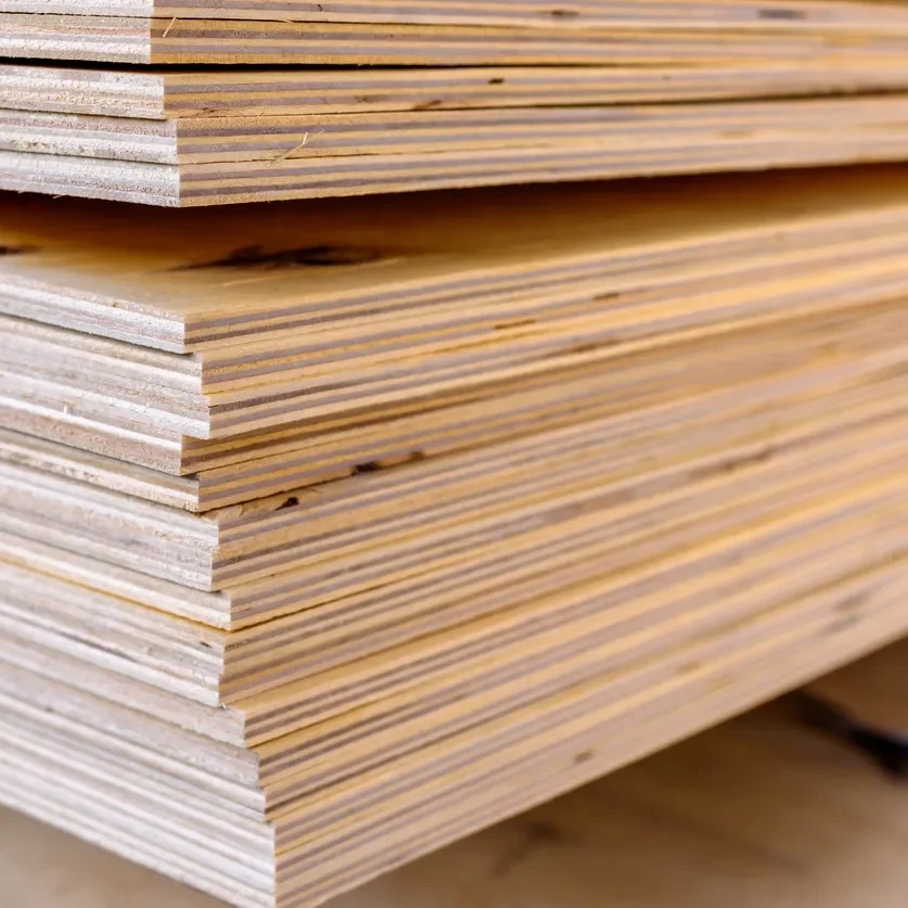 A close-up view of stacked plywood sheets, showing the layered edges and wood grain—a reflection of our customer-first approach in selecting quality materials.